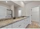 Bright bathroom featuring double sink vanity with granite countertop and a walk-in shower at 7311 Jerimoth Dr, Charlotte, NC 28215