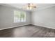 Bright bedroom with neutral walls, wood-look floors, and a ceiling fan at 7315 Gasper Ln, Fort Mill, SC 29707