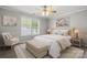 Comfortable bedroom with ceiling fan, neutral decor, and a view to the window at 7315 Gasper Ln, Fort Mill, SC 29707