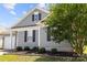 Charming single-story home featuring gray siding, black shutters, and landscaped yard at 7315 Gasper Ln, Fort Mill, SC 29707