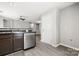 Open kitchen area with stainless steel dishwasher and view to living space at 7315 Gasper Ln, Fort Mill, SC 29707