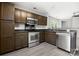Modern kitchen with stainless steel appliances, dark cabinets, and breakfast bar at 7315 Gasper Ln, Fort Mill, SC 29707