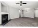 Bright living room with fireplace, ceiling fan, and wood-look flooring at 7315 Gasper Ln, Fort Mill, SC 29707