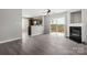 Spacious living area connected to kitchen with fireplace and access to outdoor patio at 7315 Gasper Ln, Fort Mill, SC 29707