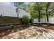 Cozy patio area with a table and chairs, enclosed by a stylish white fence and lush landscaping, perfect for outdoor relaxation at 7315 Gasper Ln, Fort Mill, SC 29707