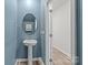 Stylish powder room featuring a modern pedestal sink and a serene blue accent wall at 853 Gerard Bay Dr, Fort Mill, SC 29715
