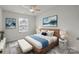 This bedroom boasts a ceiling fan and natural light from the large window at 853 Gerard Bay Dr, Fort Mill, SC 29715