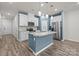 Bright, contemporary kitchen featuring stainless steel appliances, island and modern pendant lighting at 853 Gerard Bay Dr, Fort Mill, SC 29715