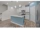 Modern kitchen featuring stainless appliances, granite counters, kitchen island and wooden floors at 853 Gerard Bay Dr, Fort Mill, SC 29715