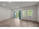 Bright living room with sliding glass doors to the deck and multiple windows for natural light at 853 Gerard Bay Dr, Fort Mill, SC 29715