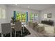 Well-lit living room with hardwood floors, neutral decor and an outdoor patio at 853 Gerard Bay Dr, Fort Mill, SC 29715