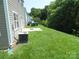 Backyard view with green grass and trees at 10516 Pickerel Ln, Charlotte, NC 28213