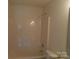 Bathroom featuring a shower-tub combo with white tiling and a sleek design at 10516 Pickerel Ln, Charlotte, NC 28213