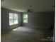 Spacious bedroom with multiple windows, carpeted floors, and neutral wall color at 10516 Pickerel Ln, Charlotte, NC 28213