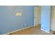Bedroom featuring blue walls, carpeted floors, with doorways leading to other rooms at 10516 Pickerel Ln, Charlotte, NC 28213