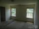 Bright bedroom featuring two windows providing natural light at 10516 Pickerel Ln, Charlotte, NC 28213