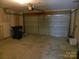 Spacious two-car garage with concrete flooring, and plenty of room for storage at 10516 Pickerel Ln, Charlotte, NC 28213
