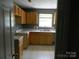 Functional kitchen with wooden cabinets, ample counter space, and a bright, airy atmosphere at 10516 Pickerel Ln, Charlotte, NC 28213