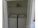 Convenient laundry room equipped with a washing machine and dryer, with storage space above at 10516 Pickerel Ln, Charlotte, NC 28213
