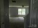 Spacious living room with ample natural light, neutral paint, and a ceiling fan at 10516 Pickerel Ln, Charlotte, NC 28213