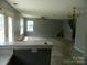 Open-concept living and dining area with access to backyard through French doors at 10516 Pickerel Ln, Charlotte, NC 28213