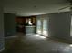 Open-concept living room with access to the kitchen and backyard through French doors at 10516 Pickerel Ln, Charlotte, NC 28213