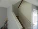 Hallway with staircase featuring neutral walls and white railings leading to the upper level of the home at 10516 Pickerel Ln, Charlotte, NC 28213