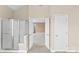 Bathroom with a walk-in shower, tiled floors, an ensuite bathroom, and neutral walls at 112 Doyle Farm Ln, Mooresville, NC 28115