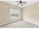 Bright bedroom features neutral walls, a ceiling fan, a window and wall to wall carpeting at 112 Doyle Farm Ln, Mooresville, NC 28115