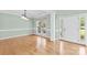 Formal dining room with hardwood floors, white trim, natural light, and view of the home's entrance at 112 Doyle Farm Ln, Mooresville, NC 28115