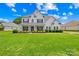 Beautiful two-story home with a manicured lawn and classic architectural features at 112 Doyle Farm Ln, Mooresville, NC 28115