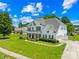 Spacious home with a large yard, driveway, and manicured landscaping at 112 Doyle Farm Ln, Mooresville, NC 28115