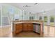 Features corner kitchen island with a double sink, stainless steel appliances and hardwood floors throughout at 112 Doyle Farm Ln, Mooresville, NC 28115