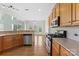 Kitchen with stainless steel appliances, hardwood floors, neutral backsplash and an adjacent dining area at 112 Doyle Farm Ln, Mooresville, NC 28115