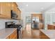 Kitchen with hardwood floors, granite countertops, stainless steel appliances and neutral backsplash throughout at 112 Doyle Farm Ln, Mooresville, NC 28115