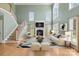 Bright, two-story living room featuring a fireplace, hardwood floors, and ample natural light at 112 Doyle Farm Ln, Mooresville, NC 28115