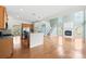 A stunning living room featuring hardwood floors, fireplace, stairs and open access to kitchen appliances at 112 Doyle Farm Ln, Mooresville, NC 28115