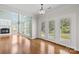 Bright living room with fireplace, hardwood floors, large windows and glass french doors leading to back yard at 112 Doyle Farm Ln, Mooresville, NC 28115