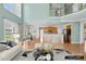 Open-concept living space features a kitchen with breakfast bar, dining area, and hardwood floors throughout at 112 Doyle Farm Ln, Mooresville, NC 28115