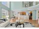 Open-concept living space features a kitchen with breakfast bar, dining area, and hardwood floors throughout at 112 Doyle Farm Ln, Mooresville, NC 28115