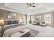 Serene bedroom with tray ceilings, a seating area, and neutral decor at 112 Doyle Farm Ln, Mooresville, NC 28115