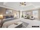 Serene bedroom with tray ceilings, a seating area, and neutral decor at 112 Doyle Farm Ln, Mooresville, NC 28115