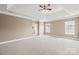 Spacious main bedroom features neutral carpet, tray ceiling, two windows, and ensuite bathroom at 112 Doyle Farm Ln, Mooresville, NC 28115