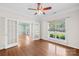 Office with hardwood floors, white trim, a ceiling fan, and large windows offering views of the front yard at 112 Doyle Farm Ln, Mooresville, NC 28115