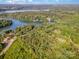 Picturesque aerial view of a lakefront property surrounded by mature trees and lush greenery at 11201 Johnson Davis Rd, Huntersville, NC 28078