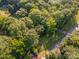 Aerial view of lush, wooded property with mature trees and a meandering road at 11201 Johnson Davis Rd, Huntersville, NC 28078