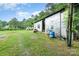 Exterior shot of a metal shed with a grassy yard and lawn mower at 11201 Johnson Davis Rd, Huntersville, NC 28078
