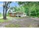 Charming single-story home with a welcoming front porch surrounded by mature trees at 11201 Johnson Davis Rd, Huntersville, NC 28078
