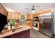 Traditional kitchen with stainless steel refrigerator, microwave and wooden cabinets, plus a kitchen island at 11201 Johnson Davis Rd, Huntersville, NC 28078