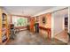 Living room featuring stone floors, brick wall, and multiple furniture sets at 11201 Johnson Davis Rd, Huntersville, NC 28078